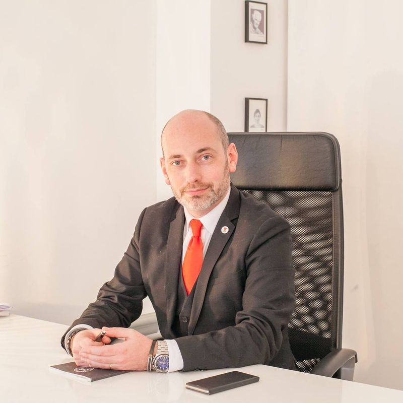 Portrait de Quentin Piepszownik, architecte, assis à son bureau.